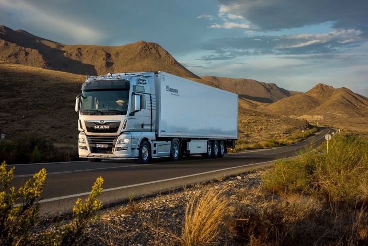 White freight truck travelling on a mountain road